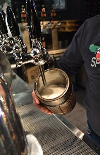 Person filling a mug with beer from a tap.