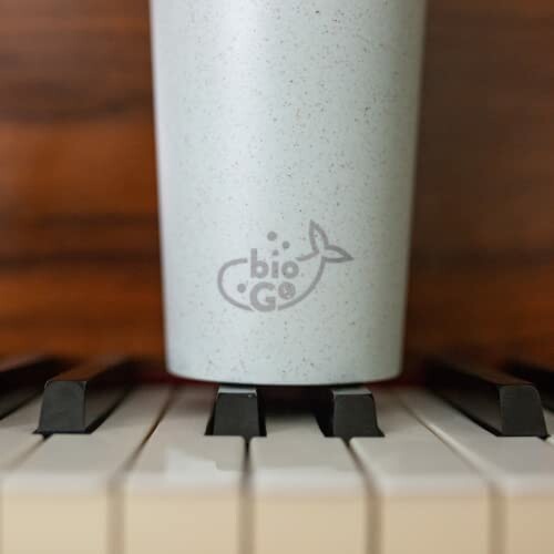 Eco-friendly cup on piano keys