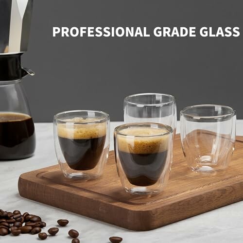 Double-walled espresso glasses on a wooden tray