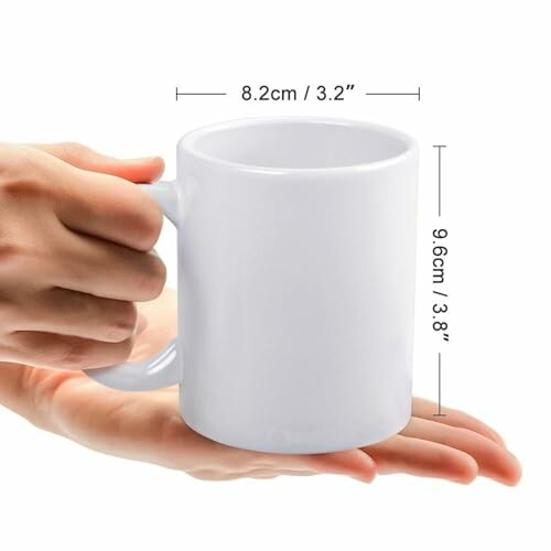 Hand holding a white mug with dimensions.