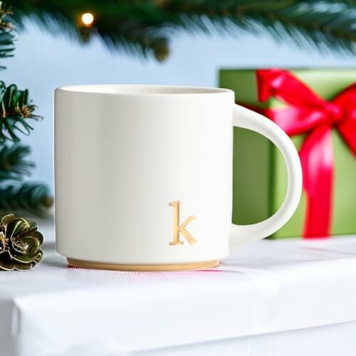 White mug with letter 'K' on gift-wrapped box